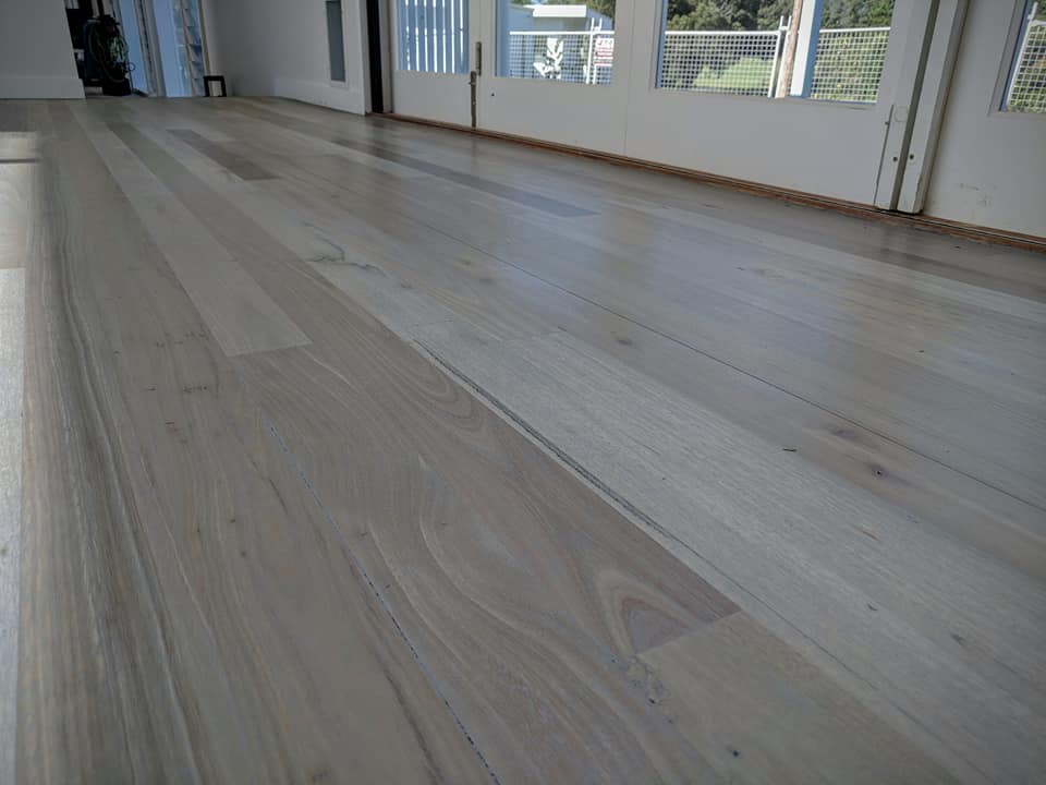 Bleached mixed hardwood room flooring.